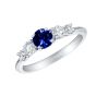  A five stone ring, in platinum, with a central round royal blue sapphire (0.70 carats) and two graduating white, round diamonds on either side 